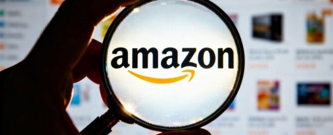Magnifying glass over Amazon logo, revealing hidden insights.