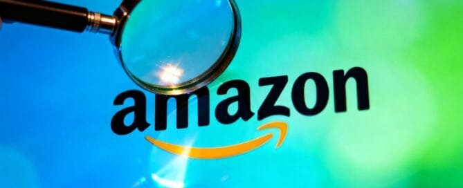 Magnifying glass over Amazon logo, symbolizing SEO.